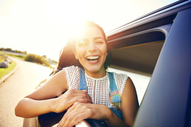 istock Cute young woman hanging her head from a car 1019427290