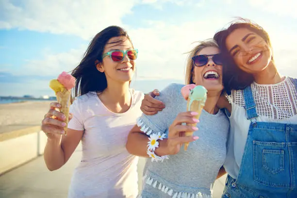 Photo of Laughing teenage girls enjoying ice cream cones