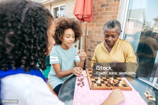 Best Grandmother And Siblings Stock Photo - Download Image Now - Playing, Chess, African-American Ethnicity