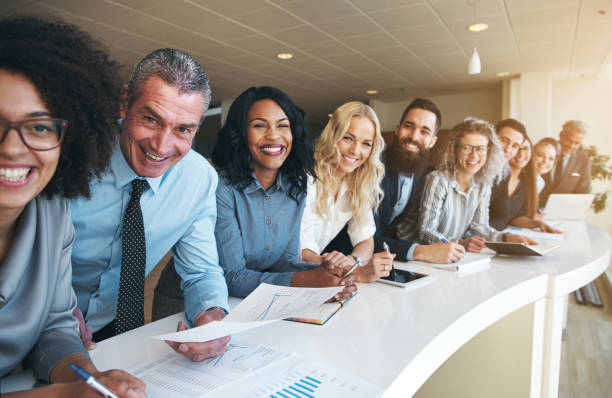 istock Coworkers in office smiling and looking at camera 1019437860
