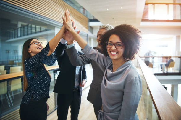istock Cheerful black woman cooperating with colleagues in office 1019437894