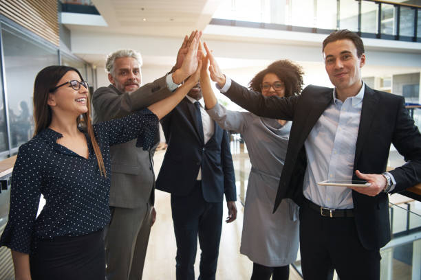 istock Business team giving high five in office 1019437914