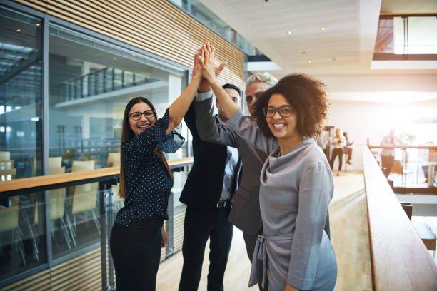 istock Multiethnic business people giving high five in office 1019437916