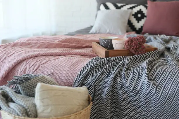 Photo of interior bedroom details textiles gray pink style