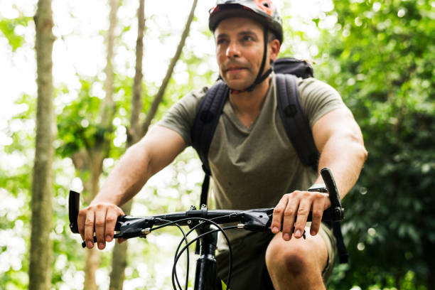 istock Happy cyclist riding through the forest 1019440970
