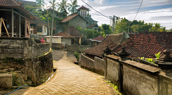 Bali Indonesia small mountainside village street lined with traditional houses