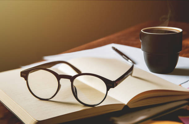 istock vintage glasses,on books stack in public library book, Studying examining. Tutor books with friends. Young students campus helps friend catching up and learning. People, learning, education 1019445534