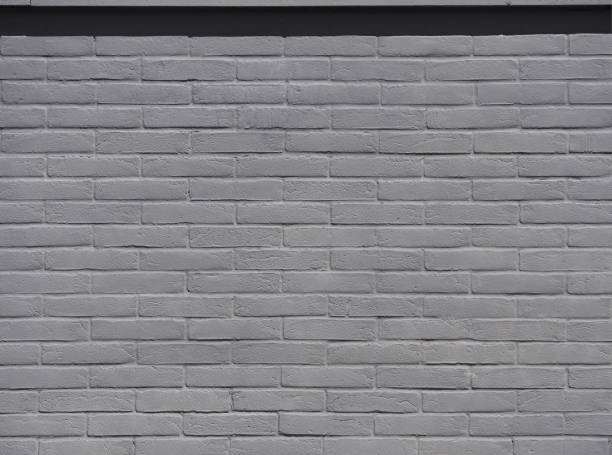 istock Gray brick wall under the sunlight. Background and texture 1019450284