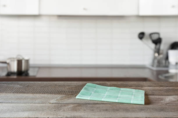 istock Blurred background. Modern defocused kitchen with wooden tabletop and space for you design. 1019452530