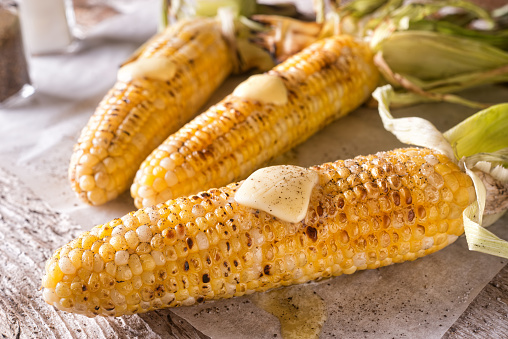 Delicious barbecue grilled corn on the cob with salt, pepper and melted butter.