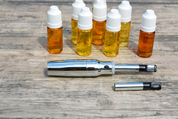 istock E - cigarette for vaping , technical devices.The liquid in the bottle 1019456748