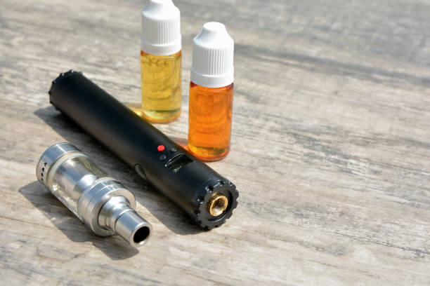 istock E - cigarette for vaping , technical devices.The liquid in the bottle 1019456778