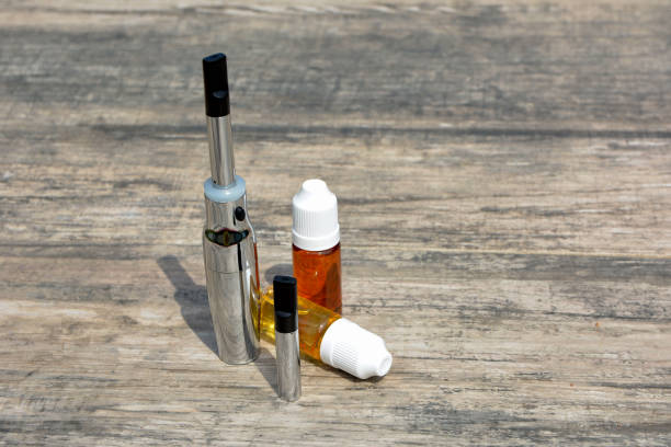 istock E - cigarette for vaping , technical devices.The liquid in the bottle 1019456932