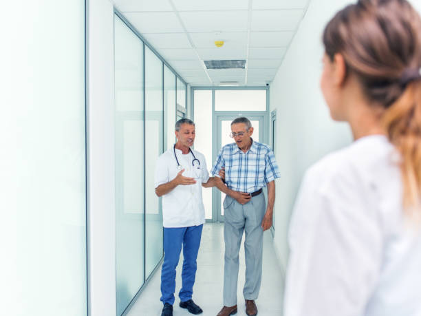 istock Doctor and senior patient talking in corridor 1019460276