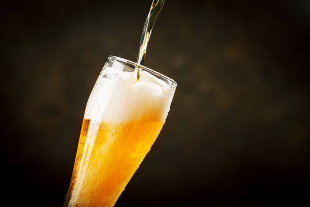 istock A glass of beer on a dark background. 1019460406