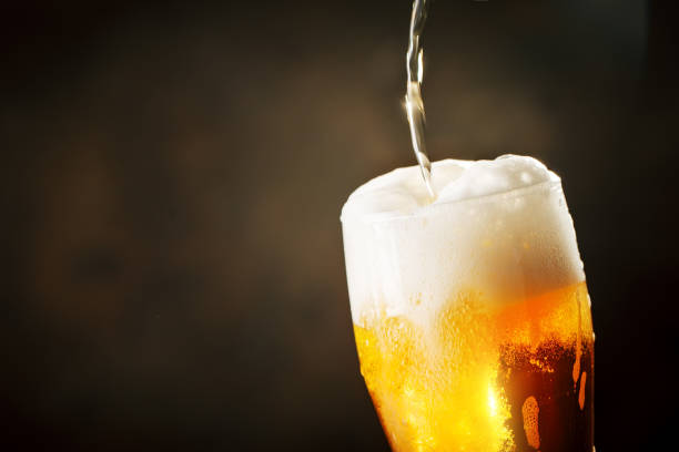 istock A glass of beer on a dark background. 1019460574