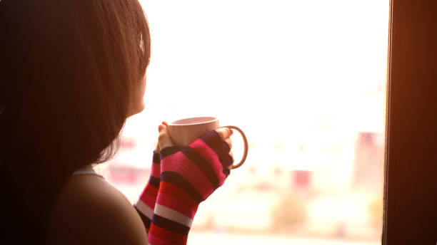 istock Girl With Coffee By The Window 1019460742
