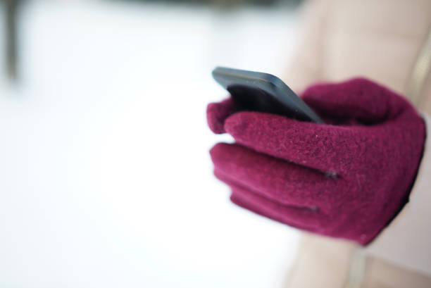Hand of woman in colorful woolen glove. Isolated on white background