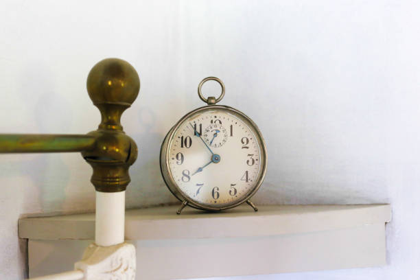 istock Vintage Alarm Clock Near Wrought Iron Bed Post 1019463384