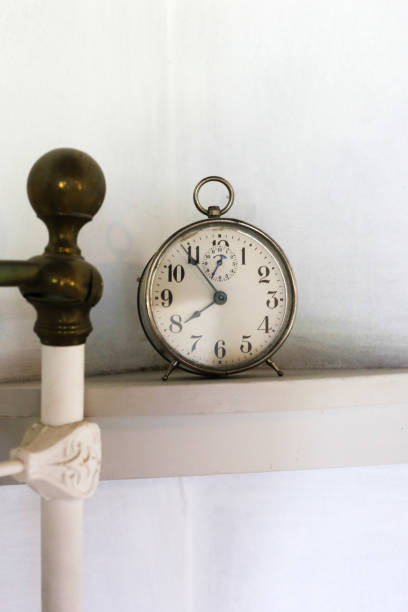 istock Vintage Alarm Clock Near Wrought Iron Bed Post 1019463476
