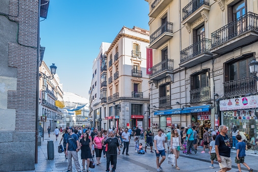 Madrid, Spain - July 27, 2018: Very busy tourist street (Calle del Carmen) near to Puerta del Sol, in Madrid Spain.