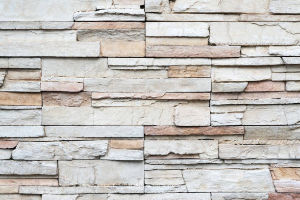 istock Close up of modern style design decorative uneven cracked real stone wall surface with cement 1019473932