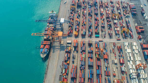 istock Container ship in export and import business and logistics. Shipping cargo to harbor by crane. Water transport International. Aerial view and top view. 1019480018