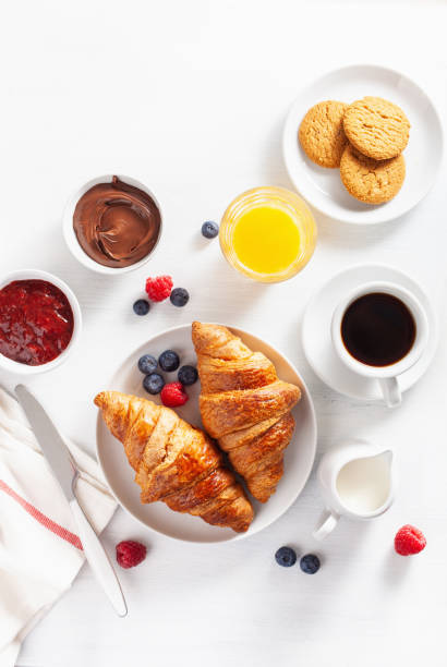 istock Continental breakfast with croissant,  jam, chocolate spread and coffee. Top view 1019485904