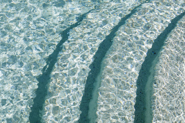 istock Sunlight and steps under the surface of swimming pool 1019486054