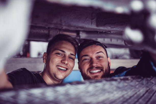 young mechanics taking selfie in canal - trainee working car mechanic imagens e fotografias de stock