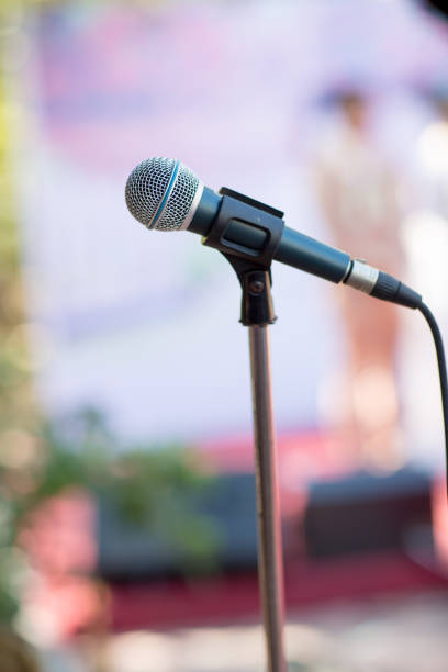 istock microphone in concert hall or conference room soft and blur style for background. 1019499150