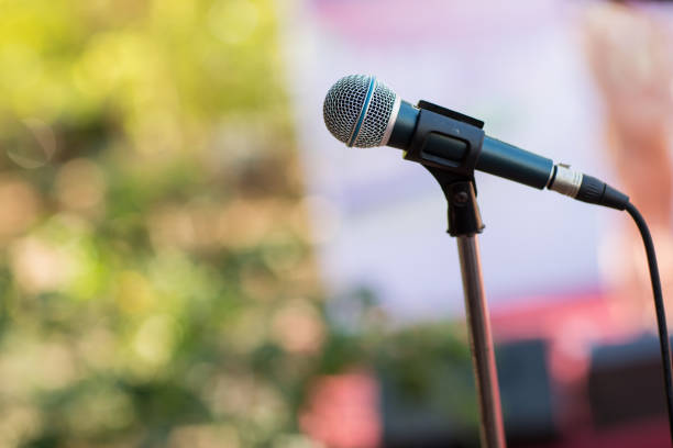 istock microphone in concert hall or conference room soft and blur style for background. 1019499586