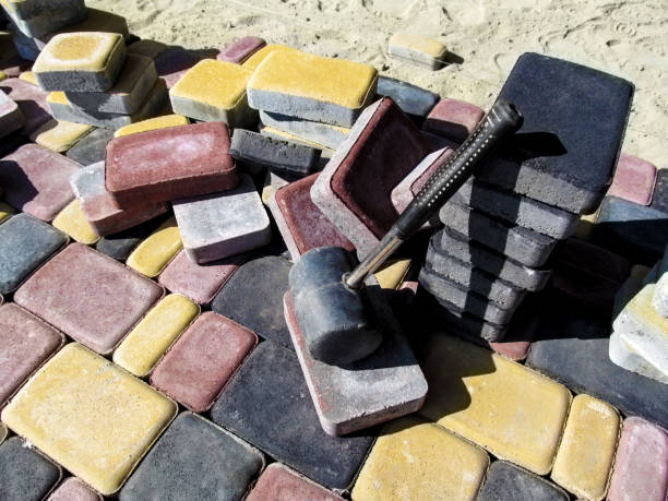 a pile of colored bricks of the tiles 'old town' and a rubber hammer for laying paving slabs - rubber mallet imagens e fotografias de stock