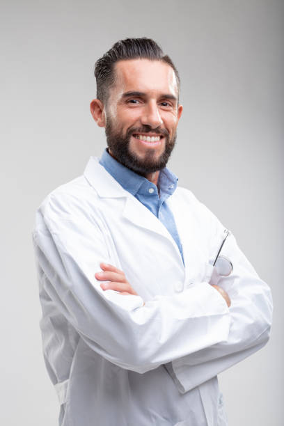 istock Smiling confident male doctor in a white lab coat 1019505444