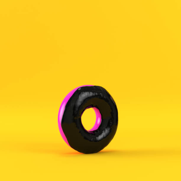 istock Donut with black glaze on yellow background 1019510664