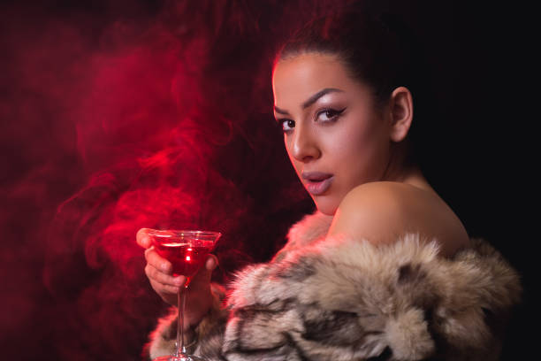 istock Brunette in fur coat with cocktail 1019510754