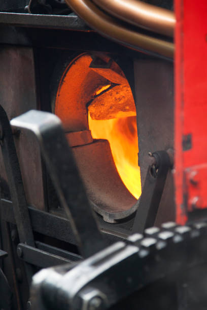 stoked fire on a heritage steam train, Derbyshire stoked fire on a heritage steam train, Derbyshire firebox steam engine part stock pictures, royalty-free photos & images