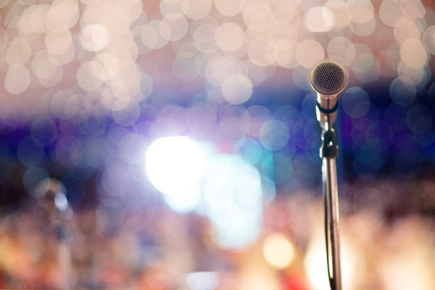 istock microphone in concert hall or conference room soft and blur style for background. 1019528576