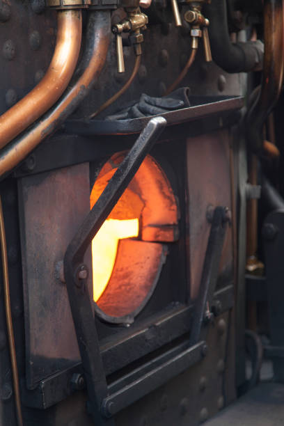 stoked fire on a heritage steam train, Derbyshire stoked fire on a heritage steam train, Derbyshire firebox steam engine part stock pictures, royalty-free photos & images