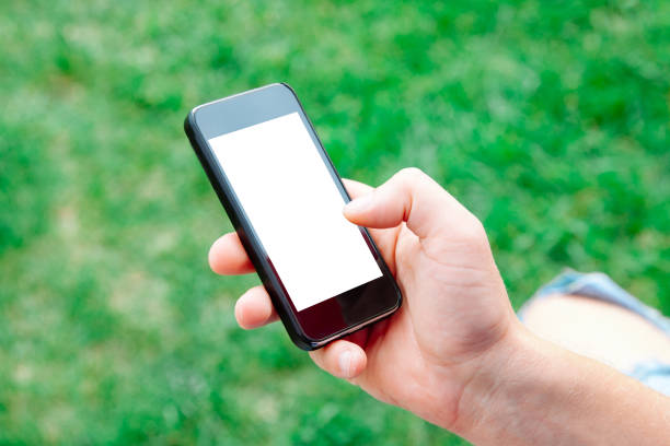 istock Man using smartphone with blank screen outdoors, closeup. Mock up for design 1019535118