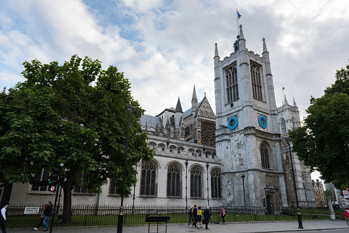 London, UK - Aug 3, 2017: St Margaret's In Westminster Parliament Square late in the day as people pass by.