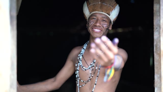 Indigenous Brazilian Young Man Beckoning and Welcoming Tourists - from Guarani ethnicity