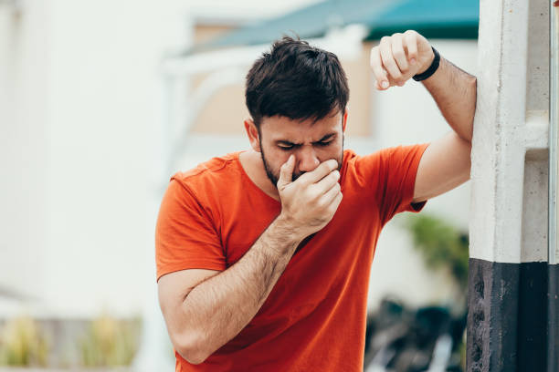 Portrait of young man drunk or sick vomiting outdoors Portrait of young man drunk or sick vomiting outdoors puke stock pictures, royalty-free photos & images