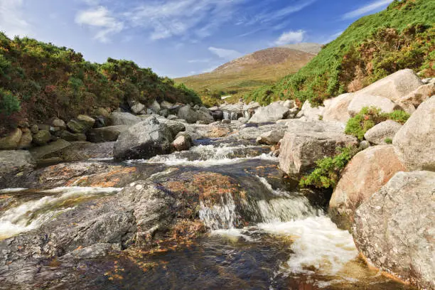 Photo of Bloody Bridge river in the Mourne Mountains, near Newcastle, Northern Ireland. Landscape, historical place, tourist route.