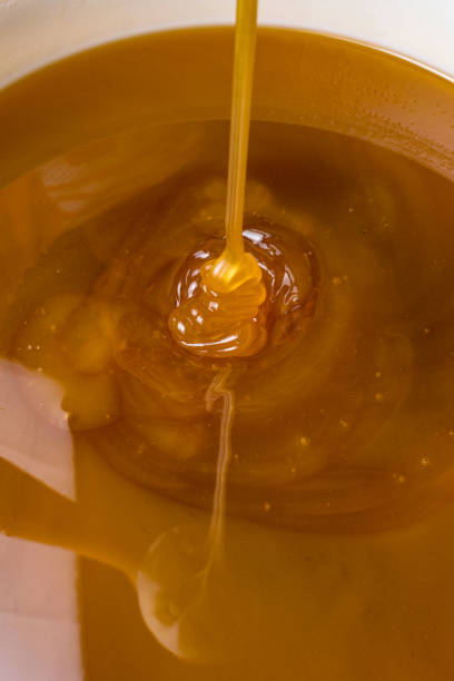 istock honey liquid background macro closeup. Helth food 1019545058