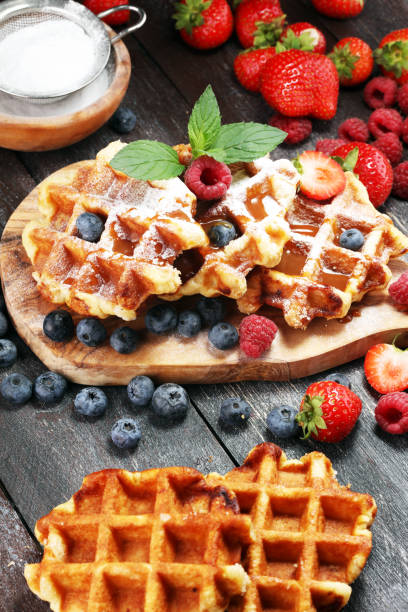 istock Traditional belgian waffles with fresh mint, sugar and raspberries. 1019548086