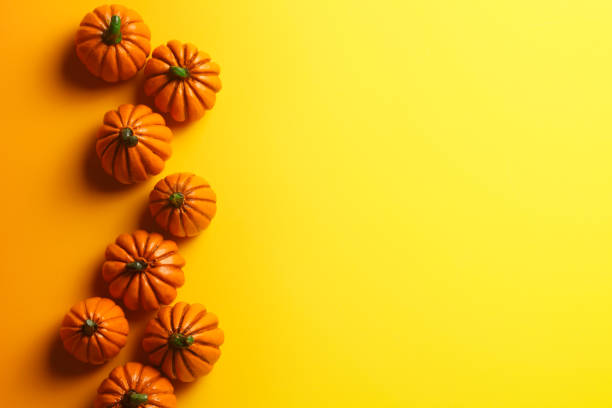 istock Group Of Toy Pumpkins On Yellow Background 1019548292