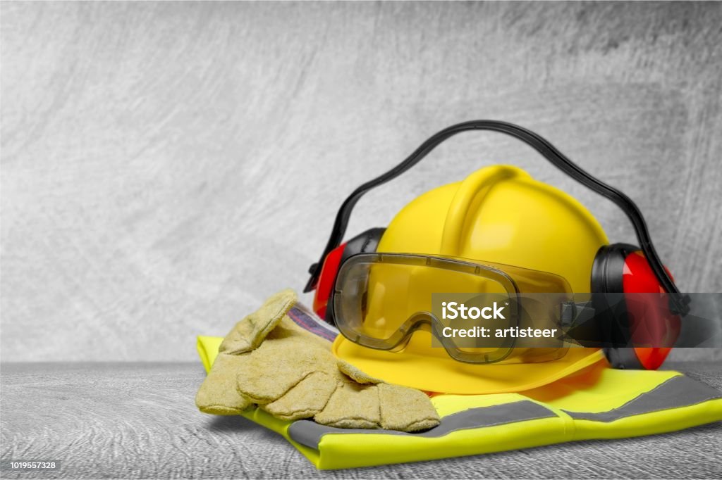 Safety. Safety helmet with earphones and goggles on construction background Safety Stock Photo