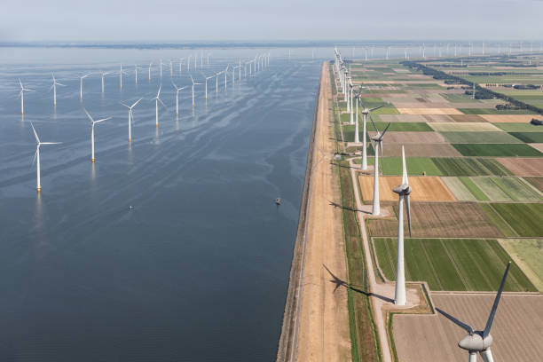 Aerial view Dutch landscape with offshore wind turbines along coast Aerial view Dutch agricultural landscape with big offshore wind turbines along the coast landscape alternative energy scenics farm stock pictures, royalty-free photos & images