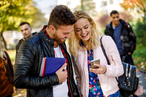 istock College students using mobile phone outdoors 1019562620